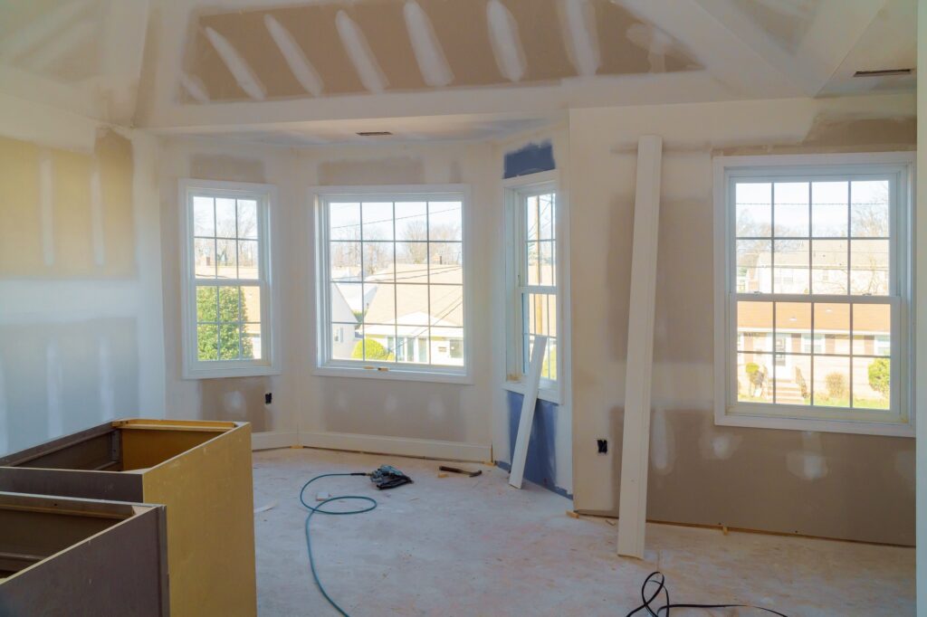 Painting applied interior construction of housing with drywall installed and patched