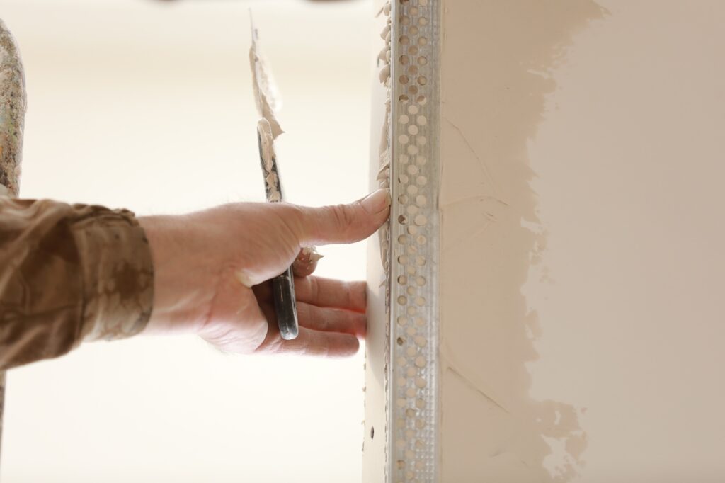 The worker set the metal wall profile in the new flat. Plasterboard metal profiles. Gypsum board ins