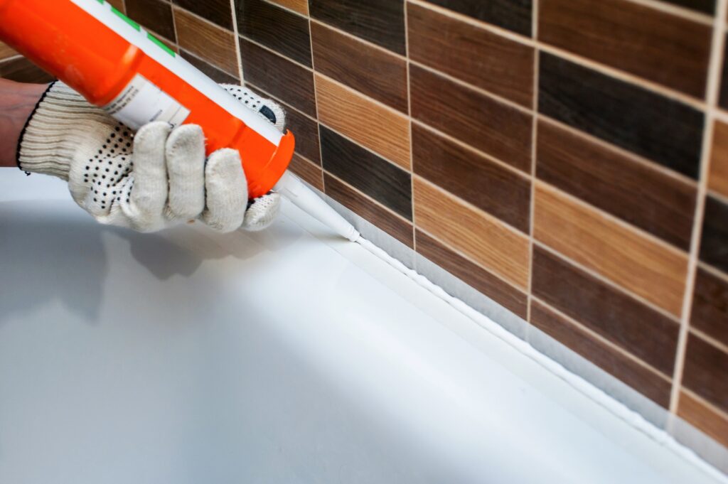 work sealing in the bathroom with silicone sealant